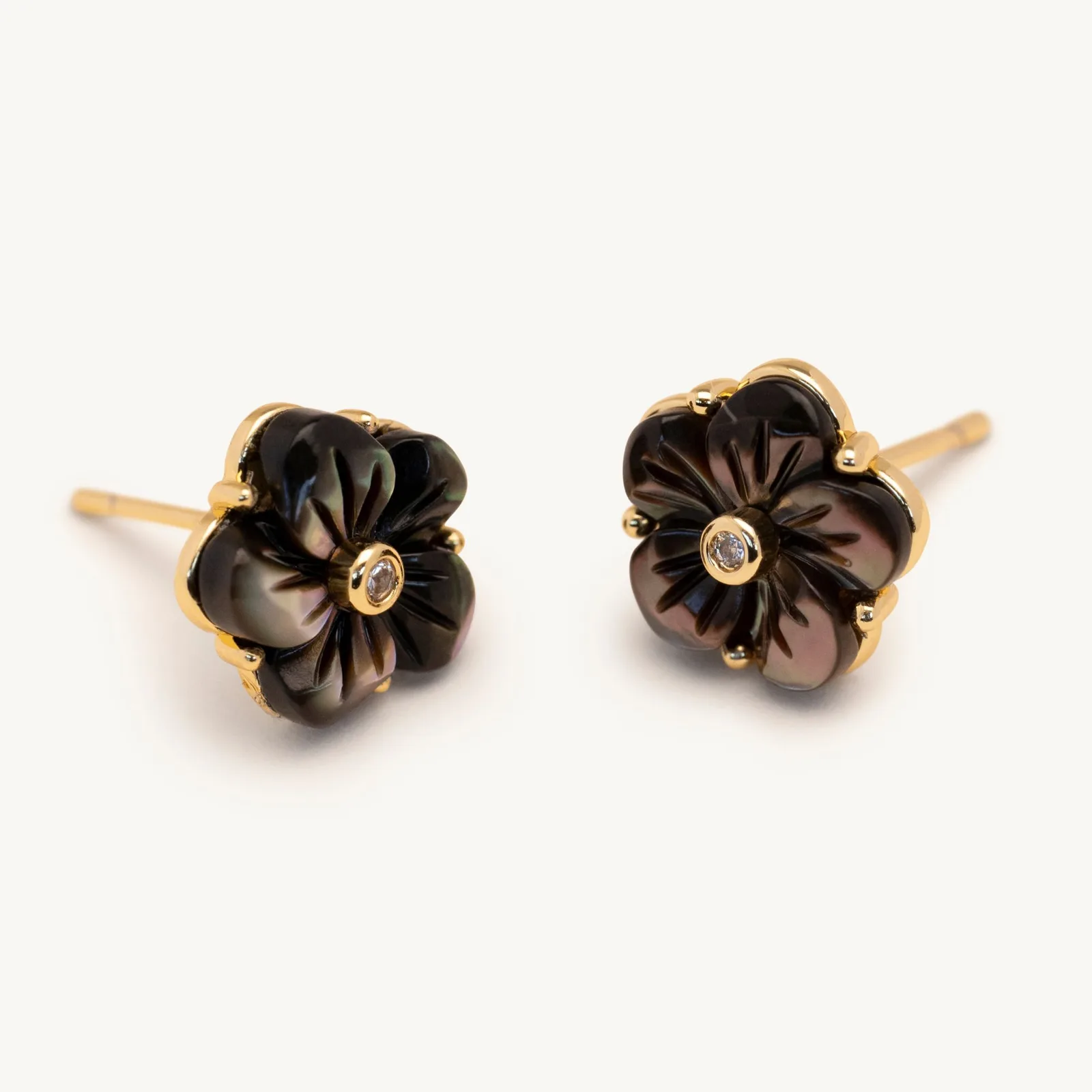 Carved dark shell flower stud earrings with a crystal centre in black