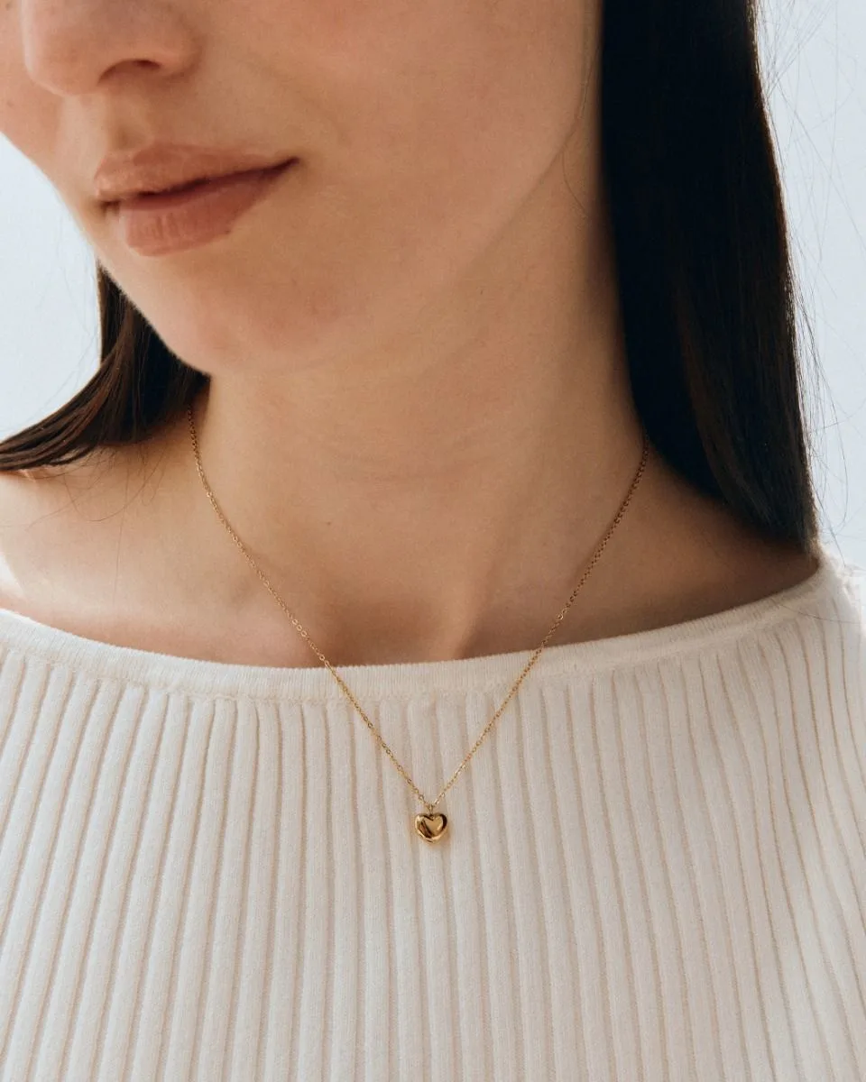 Small puffed heart pendant necklace in gold plated stainless steel