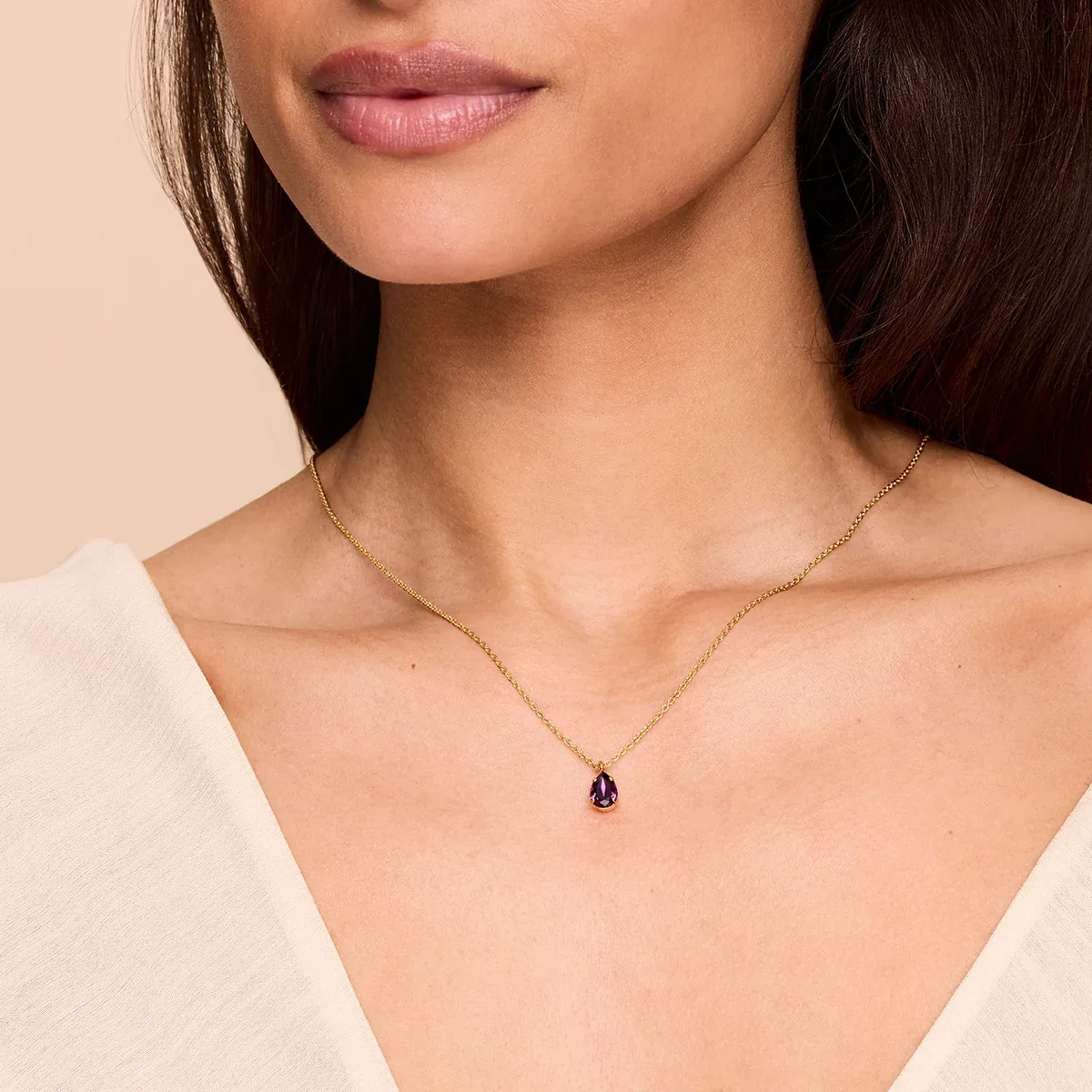 Gold necklace with a single birthstone crystal