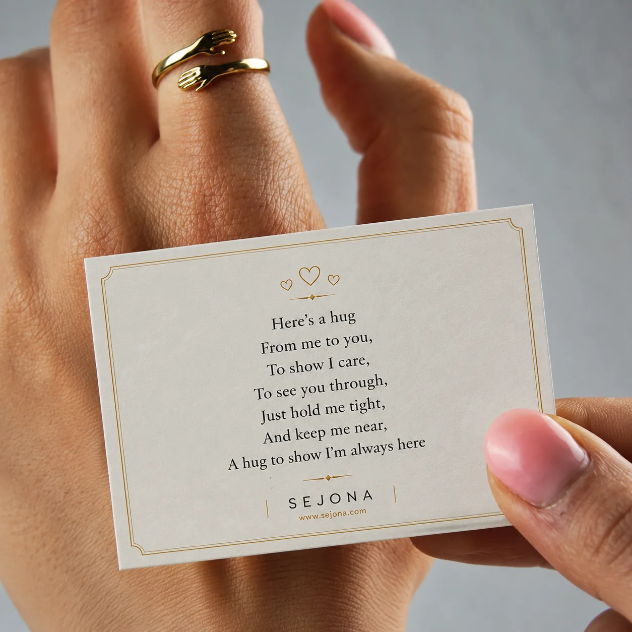 The Hug Ring worn, with the note card that ships with it