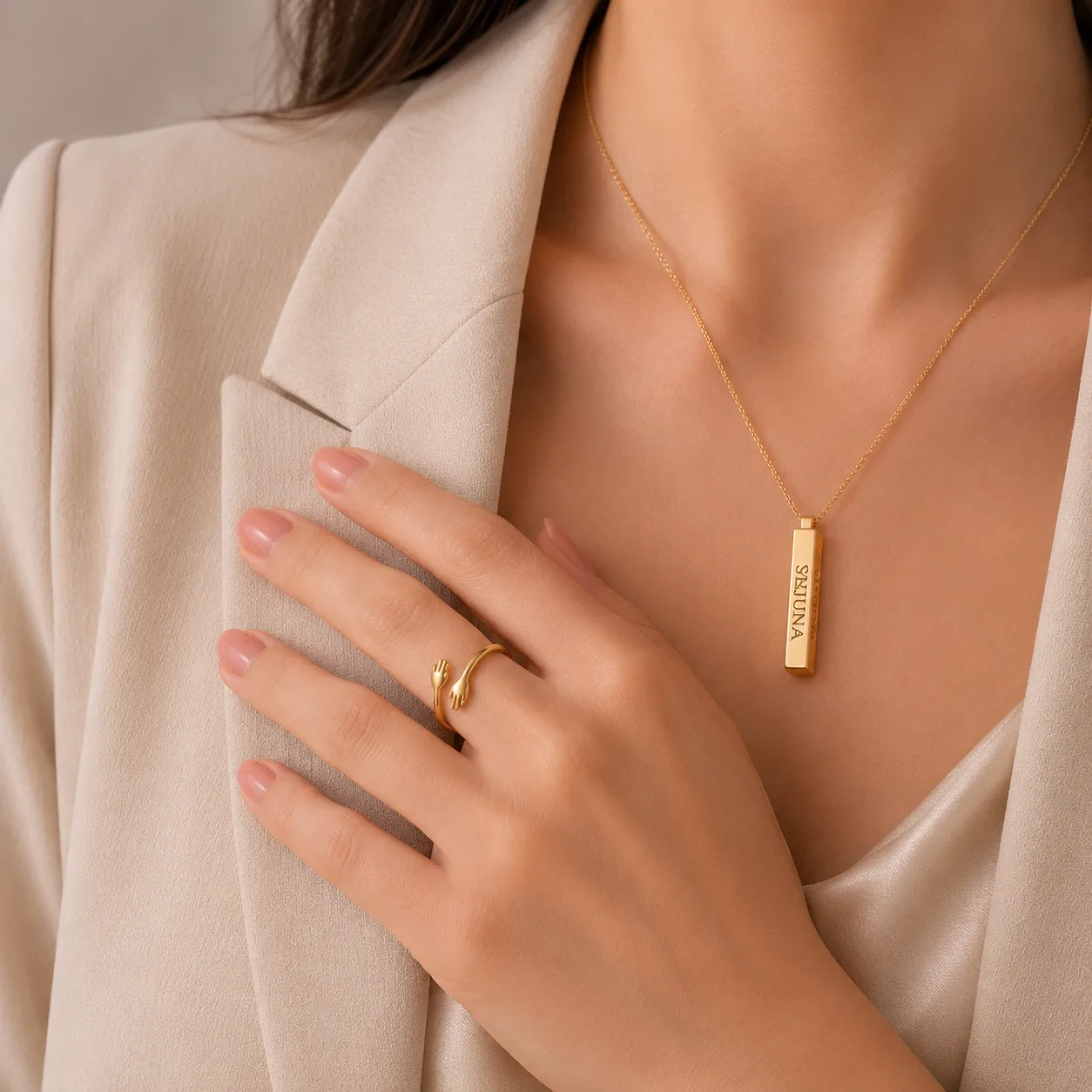 Hug Ring in gold, worn with a bar necklace