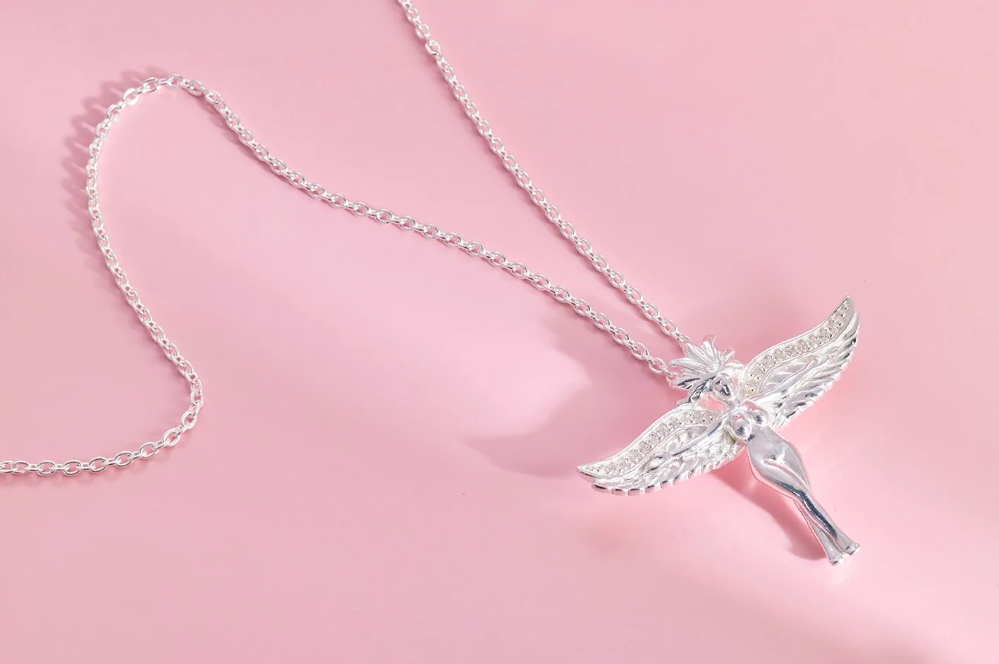 Winged figure pendant in sterling silver on a long chain